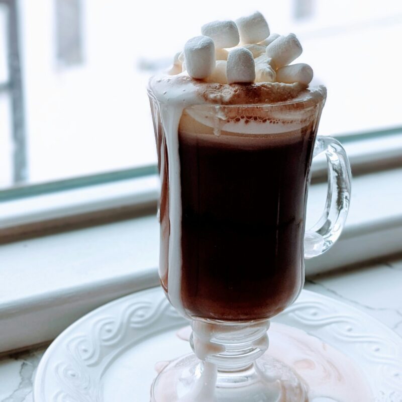 mug of hot cocoa with snow background